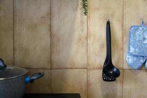 a black spatula hanging on a wall at S K apartments K in Argostoli
