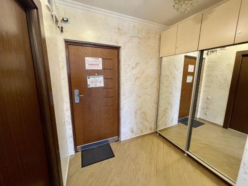 an empty hallway with doors and a mirror at Orbi Eva Aparatments in Batumi