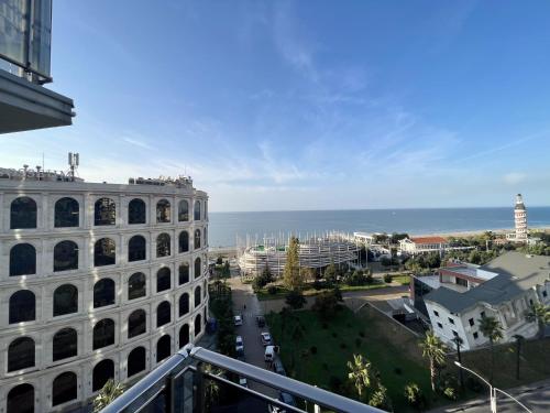 a view of the ocean from the balcony of a building at Orbi Eva Aparatments in Batumi