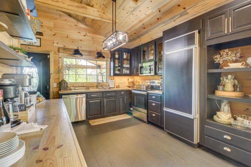 a large kitchen with wooden cabinets and a wooden floor at Great Outdoor Space Margys Farmhouse in Jasper in Jasper
