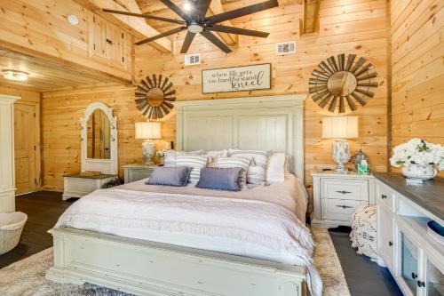 a bedroom with a white bed and wooden walls at Great Outdoor Space Margys Farmhouse in Jasper in Jasper