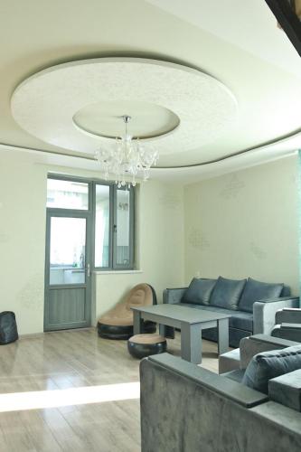 a living room with a couch and a table at Syune Syunick Shinuhayr in Shinuhayr