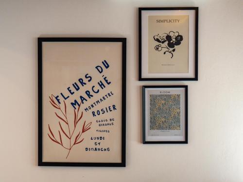 a group of four framed pictures on a wall at Andar`s people in Sarajevo