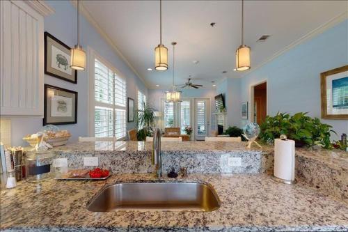 a kitchen with a sink and a counter top at Garden Cottage 23 in Jekyll Island