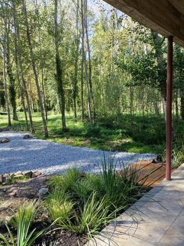 a gravel driveway in a wooded area with trees at Cuenca del Bosque in Tandil