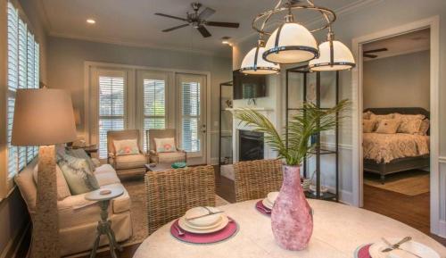 a living room with a table and a bedroom at Poolside Cottage 32 in Jekyll Island