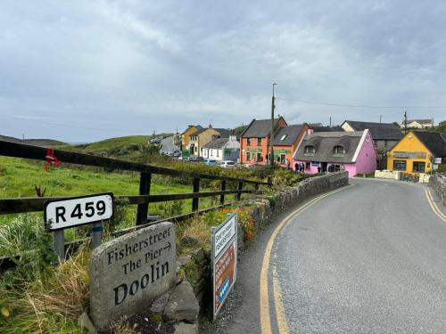 a street with a sign on the side of a road at Doolin Farm Apartment in Doolin