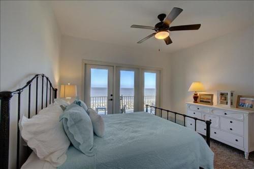 a bedroom with a bed with a stuffed animal on it at Ocean Cottage 44 in Jekyll Island