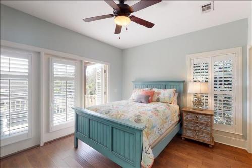a bedroom with a bed and a ceiling fan at Poolside Cottage 57 in Jekyll Island
