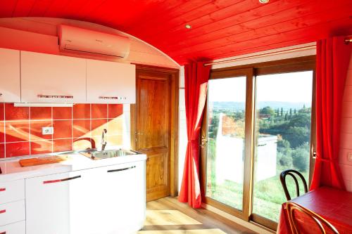 a kitchen with a sink and a large window at Poggio Diavolino - Suvereto in Suvereto