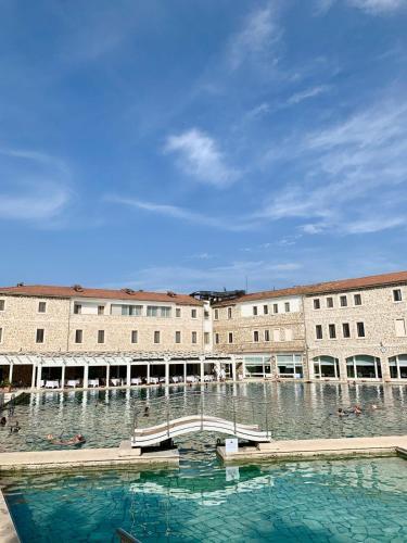a large building with a large pool of water at Casa Maria Saturnia in Saturnia