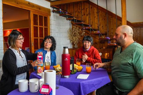 a group of people sitting around a table at Re-Crearte Centro Holístico in San Carlos de Bariloche