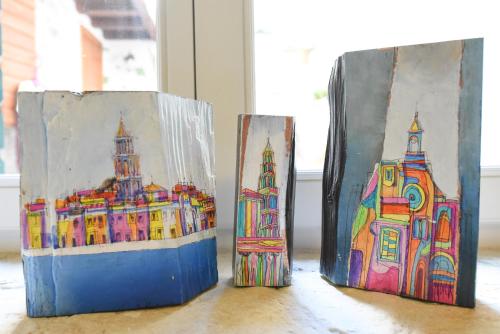three painted bags sitting on a table at Pylon Rooms in Split