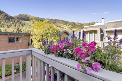 a balcony with purple flowers on a house at Lovely Aspen Condo with Mountain Views & Hot Tub in Aspen