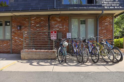 a group of bikes parked in front of a brick building at Lovely Aspen Condo with Mountain Views & Hot Tub in Aspen