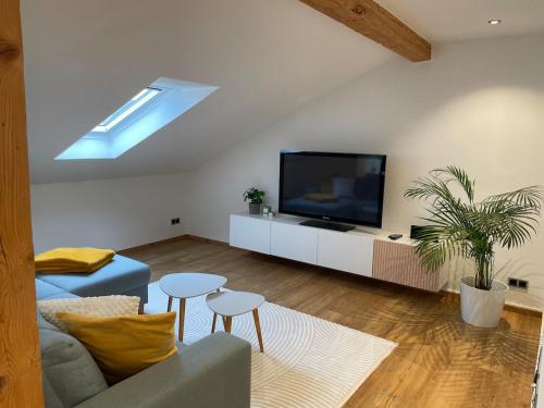 a living room with a couch and a tv at Ferienwohnung Sternblick in Marktoberdorf