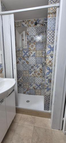 a bathroom with a shower with a tile wall at NONNA ADRIANA in Terrasini