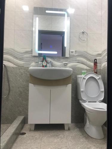 a bathroom with a toilet and a sink and a mirror at Syune Syunick Shinuhayr in Shinuhayr