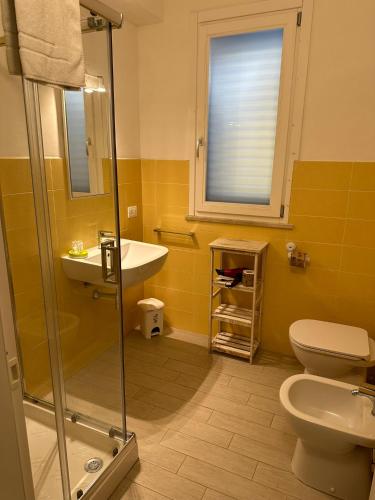 a bathroom with a sink and a toilet and a window at Favignana Holidays in Favignana