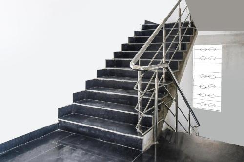 a set of stairs with a metal hand rail at HOTEL O SHIVA RESIDENCY INN in Rānchī
