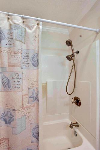 a bathroom with a shower with a shower curtain at Gritz Carlton A in Jekyll Island