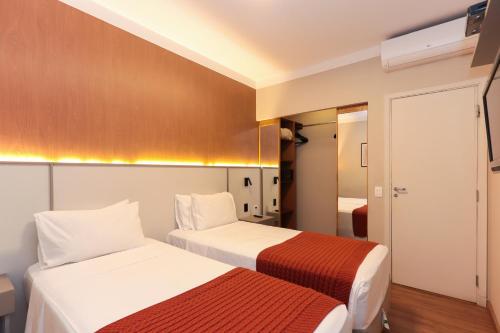 Ένα ή περισσότερα κρεβάτια σε δωμάτιο στο H4 Hotel Opera Jardins