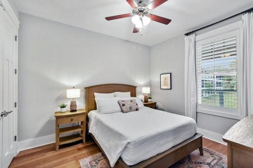 a bedroom with a bed and a ceiling fan at Moorings 104 in Jekyll Island
