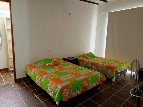 a room with two beds in a room at Finca La Ranchera No. 2 in Tarso