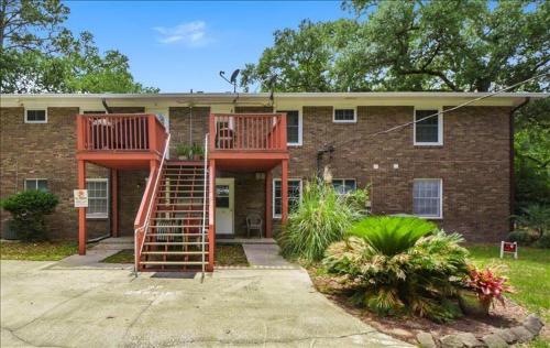a brick house with a staircase in front of it at Chicago's Hope in Jekyll Island