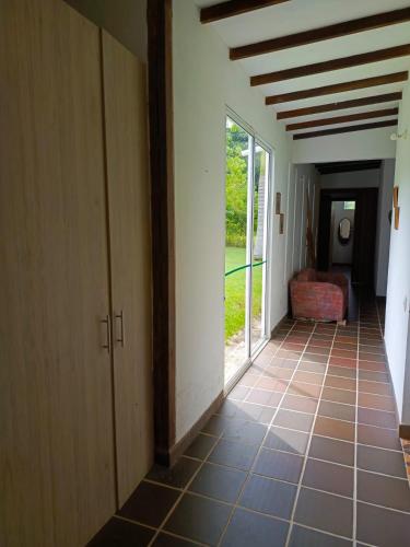 a hallway with a room with a window and a couch at Finca La Ranchera No. 2 in Tarso