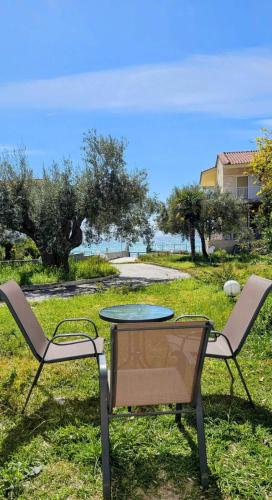 two chairs and a table and a table and chairs at Deluxe apartment by the sea in Skála Foúrkas