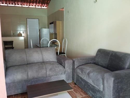 a living room with a couch and a table at Condominio Nina in Icapuí