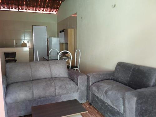 a living room with a couch and a table at Condominio Nina in Icapuí