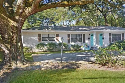 a white house with a tree in front of it at Colonel's A in Jekyll Island