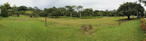 a field of grass with a fence and trees at Finca La Ranchera No. 2 in Tarso