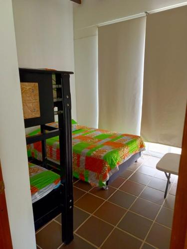 a bedroom with two bunk beds in a room at Finca La Ranchera No. 2 in Tarso