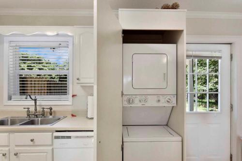 a white kitchen with a sink and a refrigerator at Gritz Carlton B in Jekyll Island