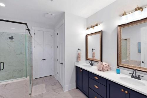 a bathroom with two sinks and a glass shower at Moorings 206 in Jekyll Island