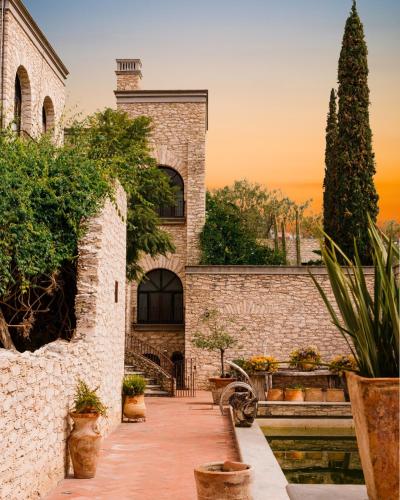 a stone house with a staircase leading up to it at Hotel Casa Mexicana in Mineral de Pozos
