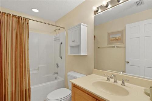 a bathroom with a sink and a toilet and a shower at At Twelve Oaks in Jekyll Island