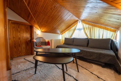 a living room with a couch and a table at Sofita Ioannina Eleousa in Eleoúsa