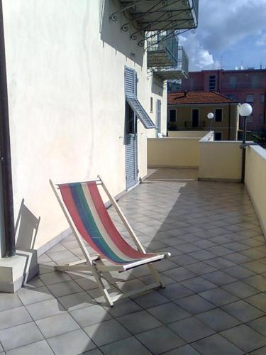a chair sitting on top of a patio at Residence Villa Carmen fronte mare a 50 mt in Pietra Ligure
