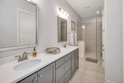 a white bathroom with a sink and a shower at Moorings 43 in Jekyll Island