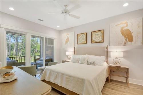 a bedroom with a bed and a room with a table at Moorings 43 in Jekyll Island