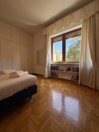 Un dormitorio con una cama y una ventana grande. en Dama St Peter Rooms, en Roma