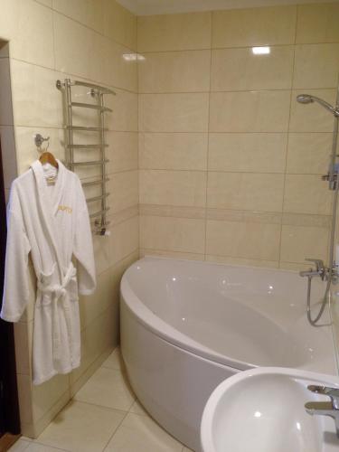 a bathroom with a bath tub and a sink at Argo in Lviv