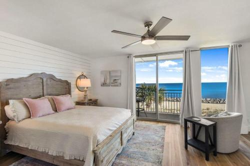 a bedroom with a bed with a view of the ocean at Villa 129 in Jekyll Island