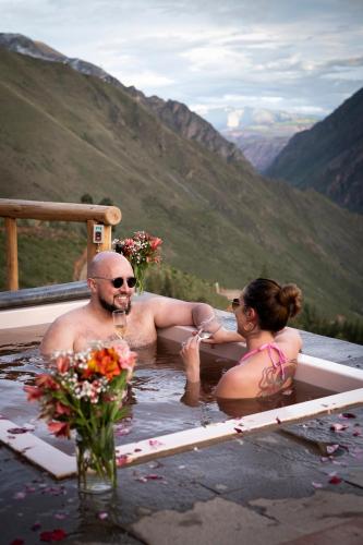 a man and a woman sitting in a bath tub at Stardome Spiritual Experience in Ollantaytambo