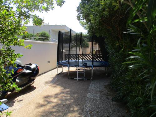a patio with a trampoline and a chair at Villa Federica in Torre Suda