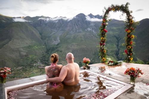 a man and a woman sitting in a bath tub at Stardome Spiritual Experience in Ollantaytambo